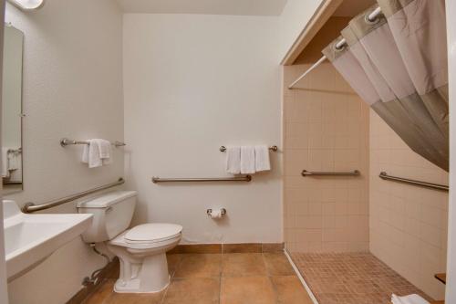 a bathroom with a toilet and a sink and a shower at Studio 6-Brownsville, TX in Brownsville