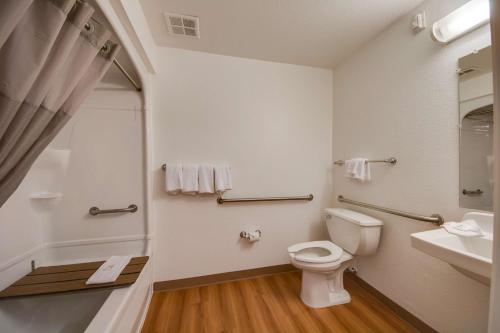 a bathroom with a toilet and a sink at Studio 6-Brownsville, TX in Brownsville