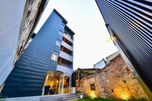 a tall brick building with a tall building at Sleep jia in Tainan