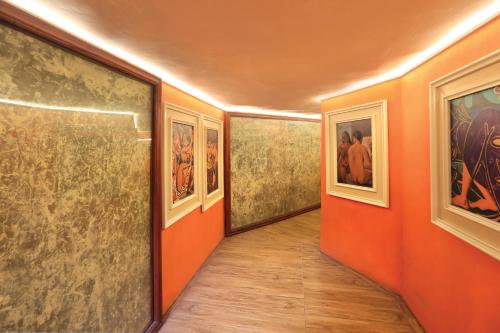an empty hallway with paintings on the walls at Fox Jaffna in Jaffna