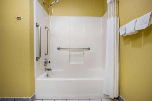 a bathroom with a shower and a white tub at Super 8 by Wyndham Crawfordsville in Crawfordsville