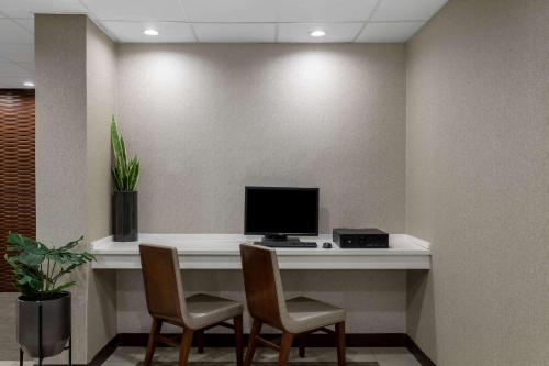 a desk with a computer on it in a room at Nobile Hotel Parkway at Celebration Orlando Very Close to Disney Theme Parks in Orlando