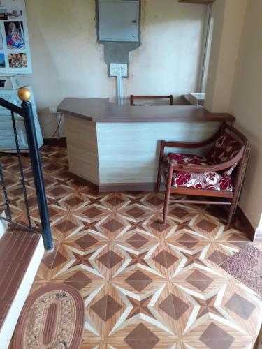 a room with a tile floor with a desk and chair at Country View Cottage Colva in Colva