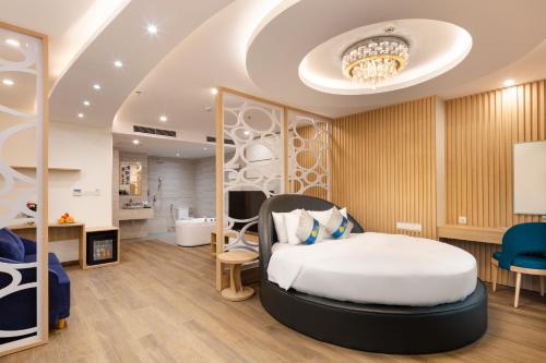 a hotel room with a bed and a bathroom at Lucky Sun Hotel Nha Trang Beach in Nha Trang