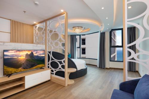 a bedroom with a bed and a tv in a room at Lucky Sun Hotel Nha Trang Beach in Nha Trang