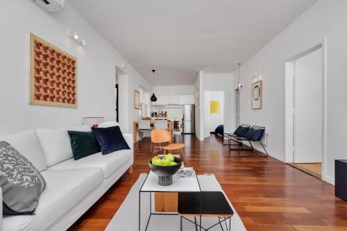 a living room with a white couch and a table at Apartments Ratac in Tučepi