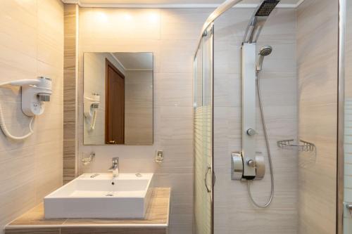 a bathroom with a sink and a shower at Green Bay in Limenaria