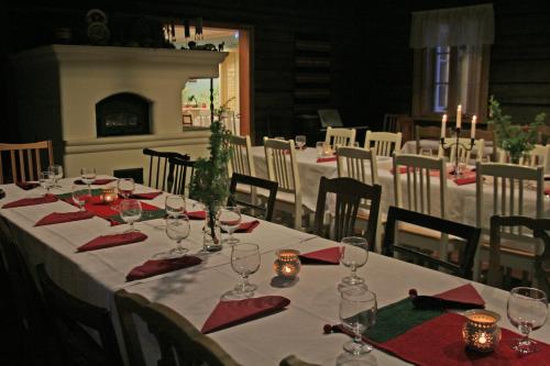 a table with red napkins and wine glasses on it at Herranniemi Guesthouse in Vuonislahti