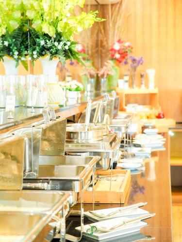 a row of sinks and utensils in a kitchen at Crystal Jade Hotel in Rayong