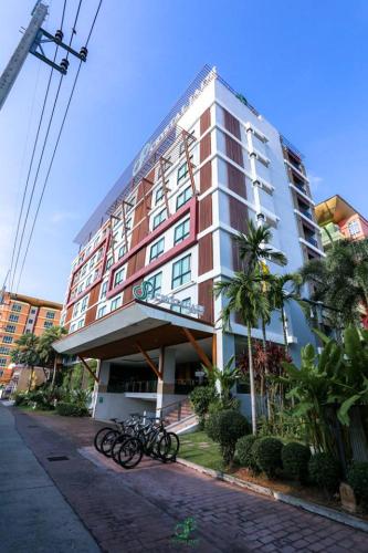 a large building with bikes parked in front of it at Crystal Jade Hotel in Rayong