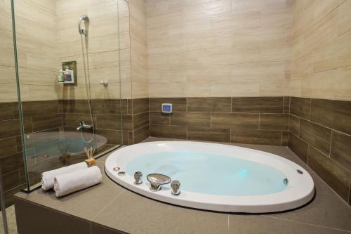 a bathroom with a large tub and a shower at Duo Romance Hotel in Hualien City