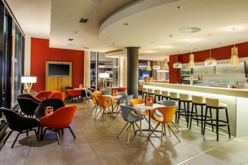 a restaurant with tables, chairs, and tables in it at Novotel Berlin Mitte in Berlin