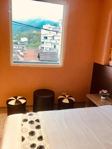 Ένα ή περισσότερα κρεβάτια σε δωμάτιο στο Night Sea Homestay