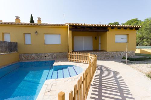 a villa with a swimming pool in front of a house at INNOUTHOME Villa Tord in L'Ametlla de Mar