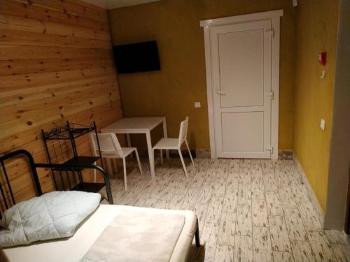 a bedroom with a bed and a table and a door at Svitiaz Griada in Szack