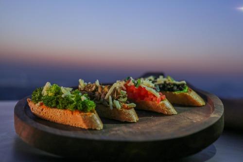 a plate with four pieces of bread with vegetables on it at Mercure Hyderabad KCP Banjara Hills, An Accor Hotel in Hyderabad