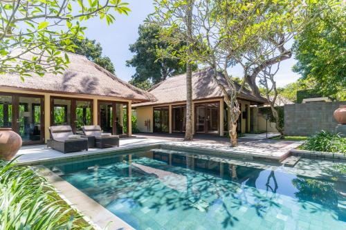 an exterior view of a villa with a swimming pool at Kayumanis Nusa Dua Private Villa & Spa in Nusa Dua