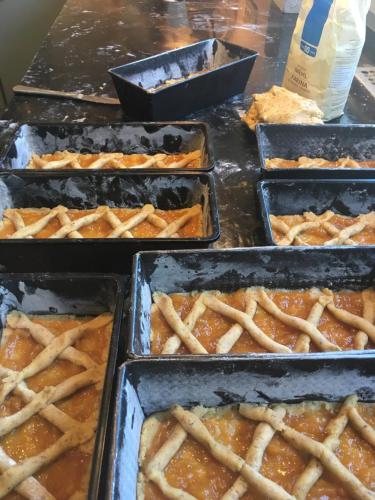 a bunch of trays of food on a table at Arya Alpine Lodge in Selva di Val Gardena