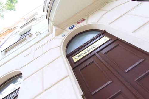 a brown door on the side of a building at Prague - Karlin Apartments in Prague