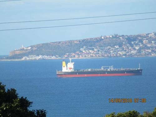a large container ship in the water with a city at Lewensdroom Self Catering in Tergniet