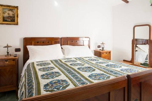 a bedroom with a bed with a quilt on it at B&B La Baita in Aritzo