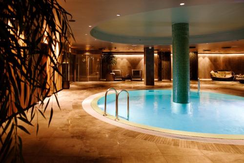 a large swimming pool in a hotel lobby at Clarion Hotel The Hub in Oslo