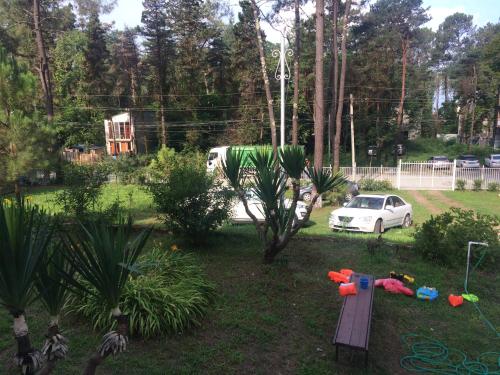 a backyard with a white car parked in a yard at Private Cottage at the Black sea in Shekvetili