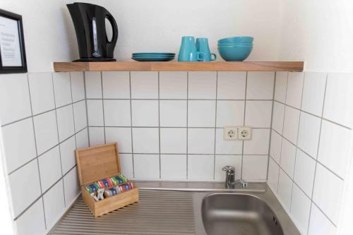 a kitchen sink with a box next to it at Central Apartments Nürnberg-Fürth in Fürth