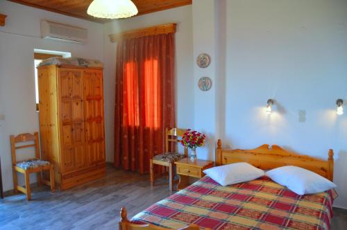 a bedroom with a bed and a table and a dresser at Mpaliaka Myrsini in Mythimna