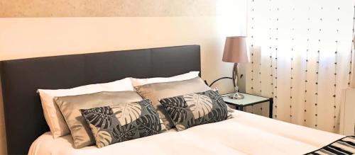 a bed with a black headboard and pillows on it at VENUS DE BAEZA SUITE in Baeza