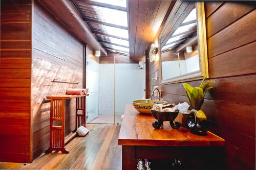 a bathroom with a sink and a mirror at GajaPuri Resort Koh Chang in Ko Chang