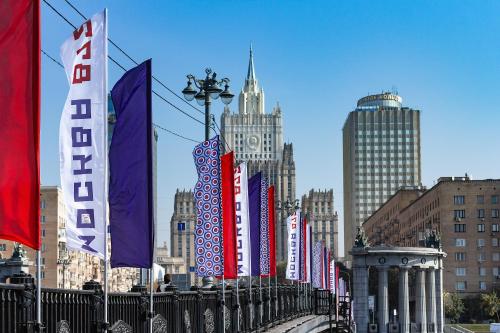 a row of flags on a fence in a city at Golden Ring Hotel in Moscow