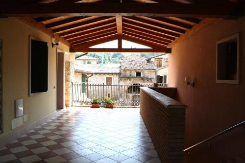 an outdoor patio with awning and a tile floor at Bed&Wine in Negrar