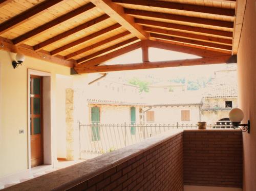 a view from the balcony of a house with a wooden roof at Bed&Wine in Negrar