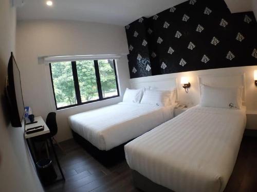 Ένα ή περισσότερα κρεβάτια σε δωμάτιο στο Apex Boutique Hotel @ Bandar Sunway