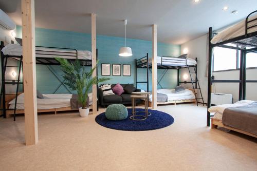 a room with two bunk beds and a table at UCHI Living stay NAKAJIMA park in Sapporo