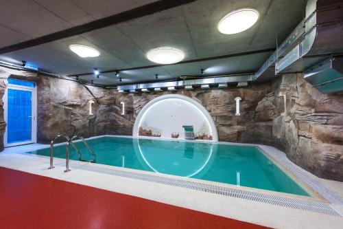 a swimming pool with a pool table and a tub at Авторский Отель Бронзовый Кабан in Voronezh