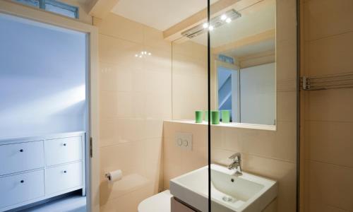 a bathroom with a sink and a mirror at Kollmann Rooms and Apartments in Ljubljana