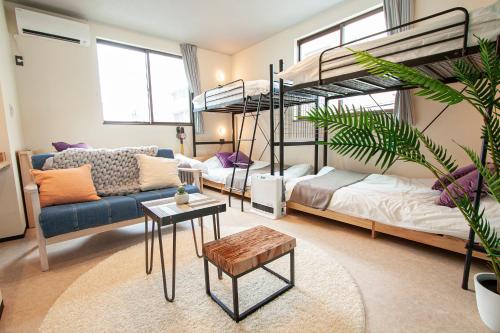 a living room with two bunk beds and a couch at UCHI Living stay NAKAJIMA park in Sapporo