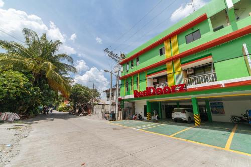 a colorful building on the side of a street at RedDoorz near Notre Dame of Dadiangas University in General Santos