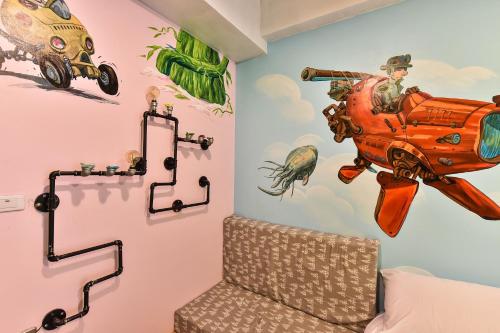 a room with a wall with a painting of a car on the wall at Anping Wikid Design Hotel in Tainan