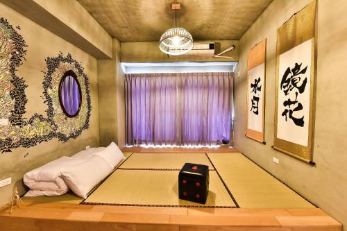 a room with a bed with a dice on it at Anping Wikid Design Hotel in Tainan