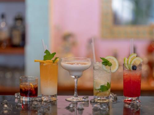 a group of four different cocktails on a table at Hotel Olimpo le Terrazze in Letojanni