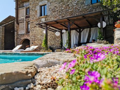 a resort with a swimming pool and a building at Mas el Mir in Ripoll