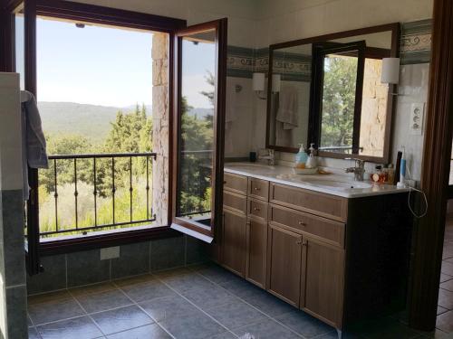 a bathroom with a sink and a window with a view at Villa Lavendel in Montauroux