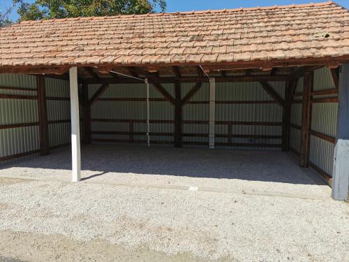 a large wooden pavilion with a brown roof at APARTMAN i SOBA HADELA in Sveti Martin na Muri