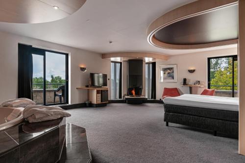 een grote slaapkamer met een bed en een balkon bij Hotel Iselmar in Lemmer