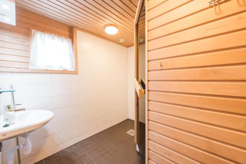 a bathroom with a sink and a toilet at Hotelli Messilä in Lahti
