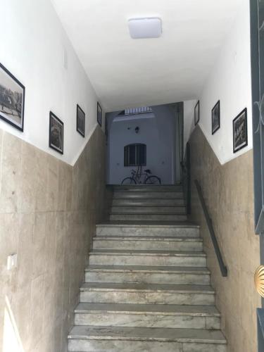 a stairway leading up to a building with a bike at Le Dimore Degli Archi Catania in Catania