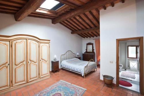 a bedroom with a bed and a dresser at Appartamenti Ruggini in Florence